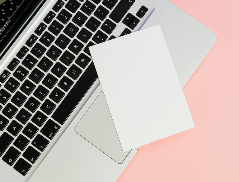 a laptop computer and a note pad on a pink background, showing communication with researchers
