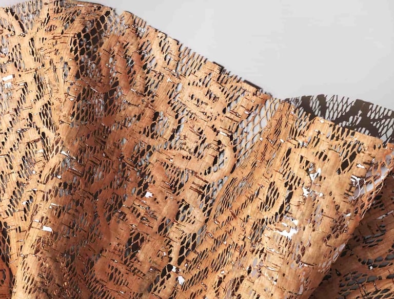 Eco-friendly sustainable laser-cut natural cork fabric with a mesh pattern for fashion design.