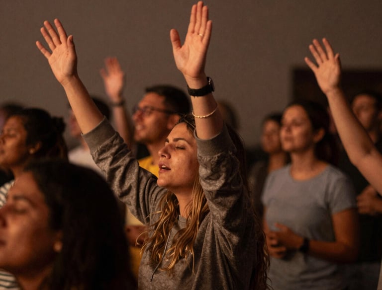 A small group of diverse men and women studying the Bible together in a cozy room filled with natural light.