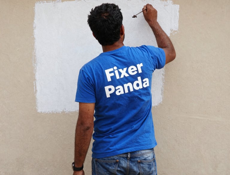 A freshly painted wall in vibrant blue and orange tones reflecting Fixer Panda’s brand colors.