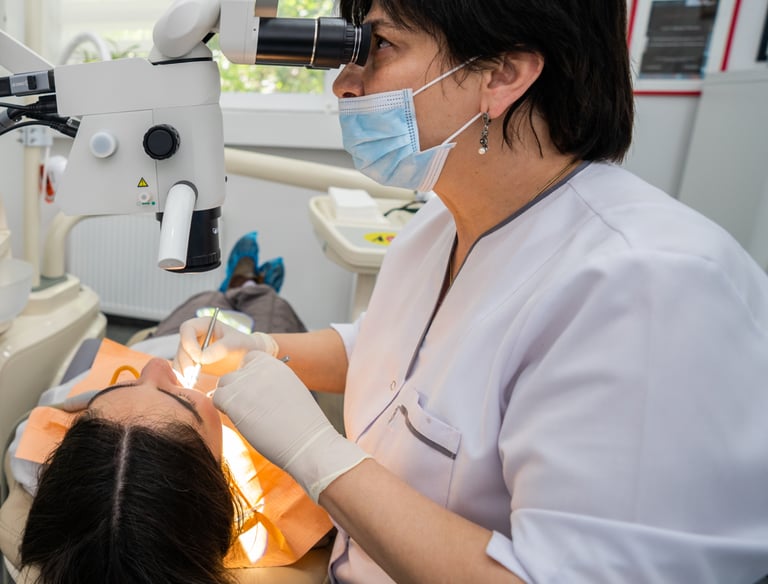 Dentist performing dental treatment on patient in modern clinic in Tbilisi