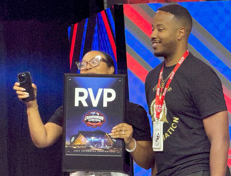 Young man and woman holding RVP award