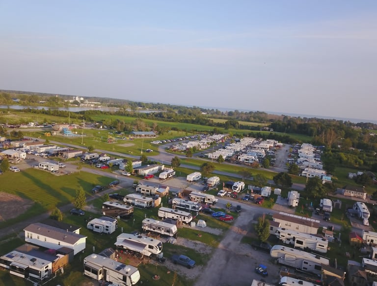 Aerial view of a lakeside RV park and campground with motorhomes and travel trailers.