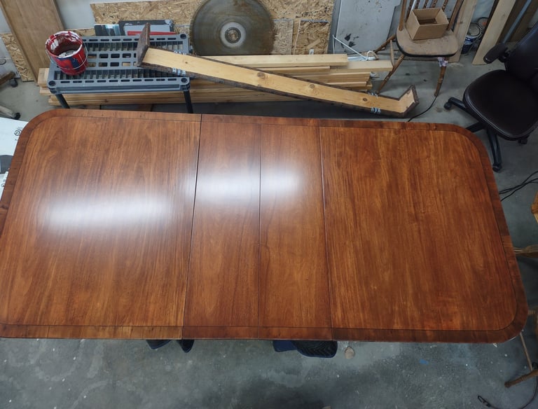 A vintage veneer dining table from the early 1970's restored to its former glory.