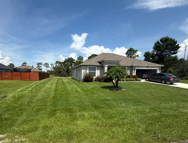 a house with a car parked in the grass