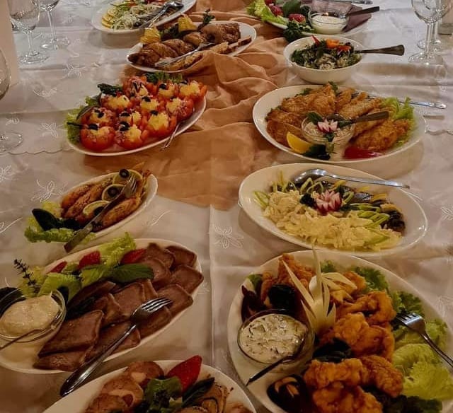 a long table with plates of food and glasses