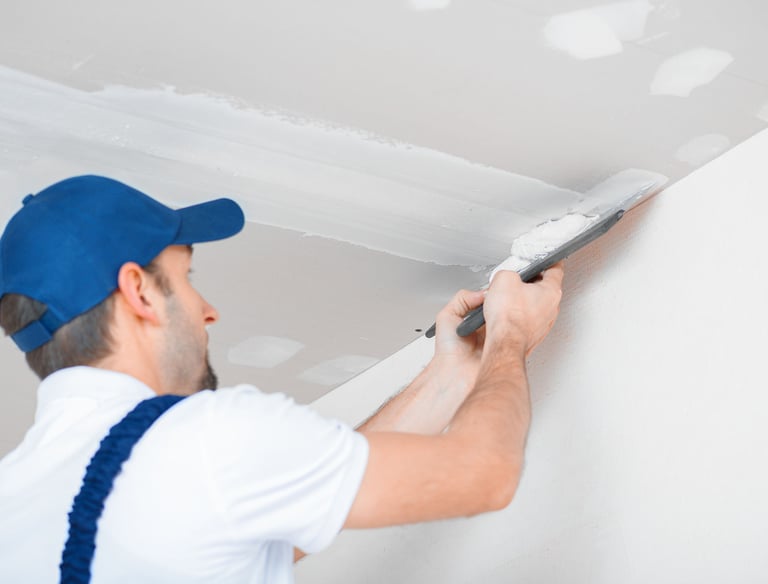 Drywall contractor mudding seams in ceiling