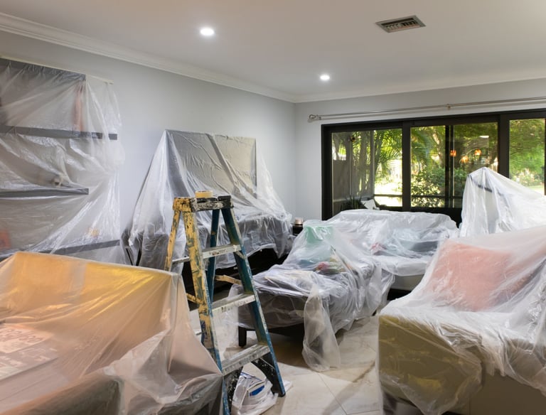 prepped and draped room with contractor tools