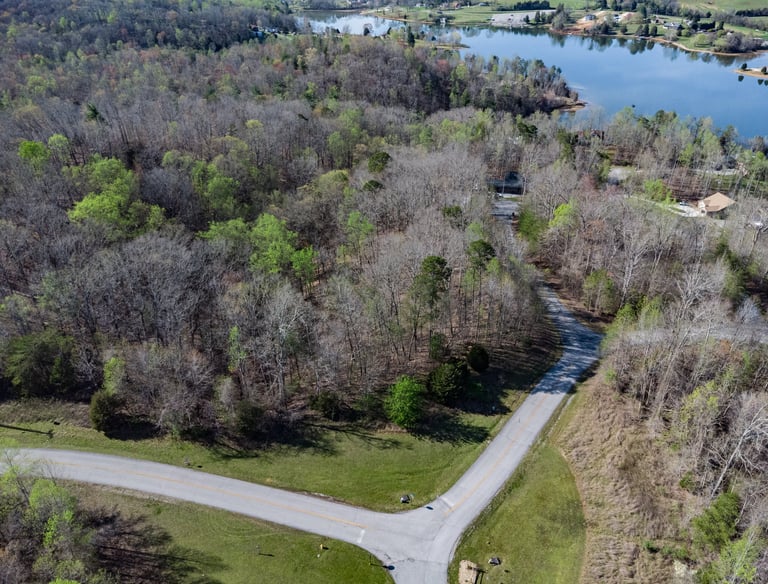 Aerial drone image of raw land and lake.