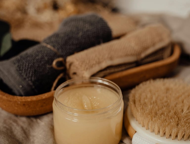 a brush, cloth and candle on a table