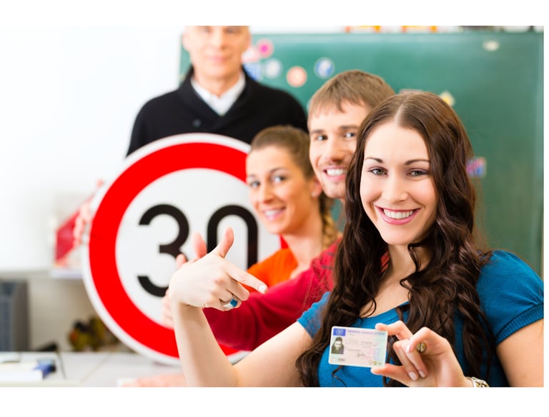 17 plus Lerner drivers with let's pass 1st instructor holding a card and pointing at a speed limit