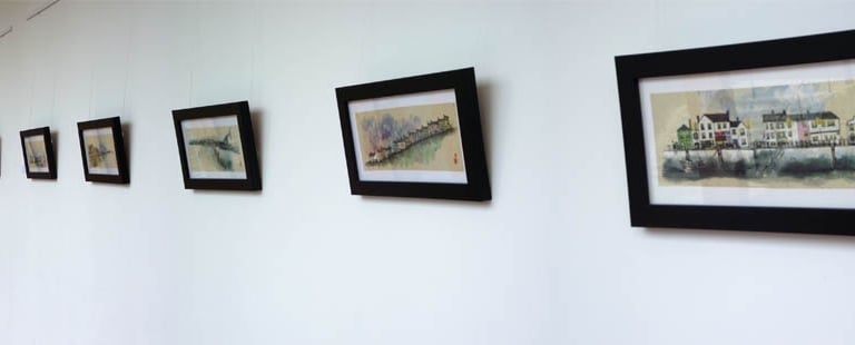 a hallway with framed pictures of a hallway