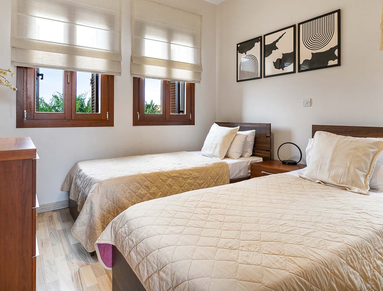 Stylish guest bedroom with convertible twin beds at Theseus Retreat holiday rental