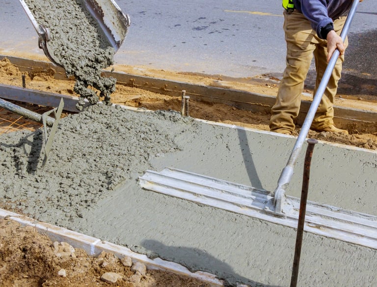 a man is pouring concrete into a concrete slab
