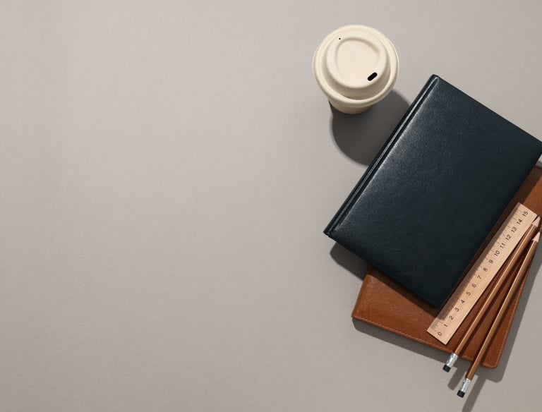 a notebook with a cup of coffee and a notebook