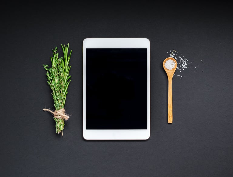 a tablet with a wooden spoon and a wooden spoon next to a wooden spoon