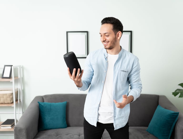 a man in a blue shirt is holding a tablet computer