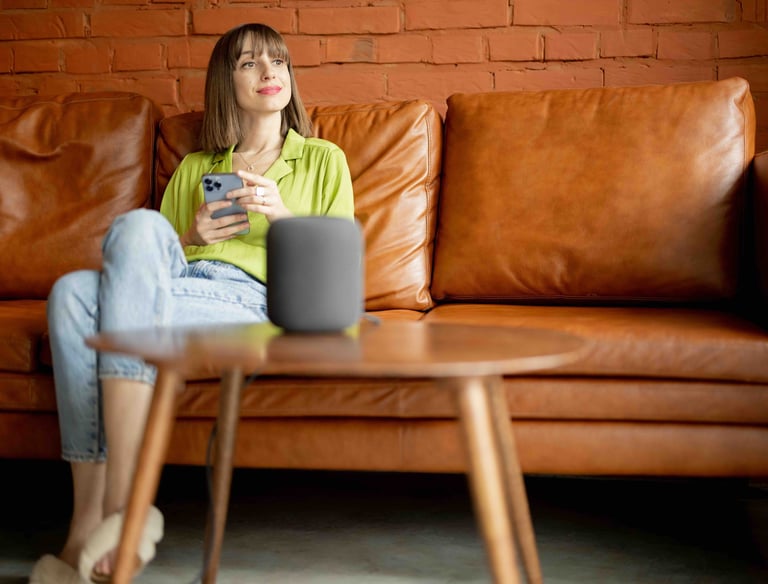 a woman sitting on a couch with a cell phone