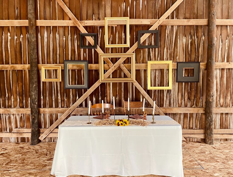 head table at wedding reception in a vintage barn