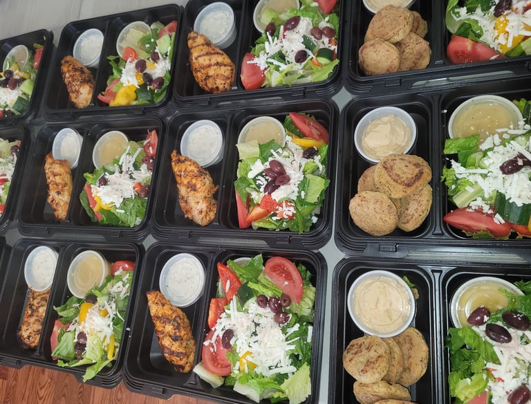 Individual meals with chicken or falafel and greek salad