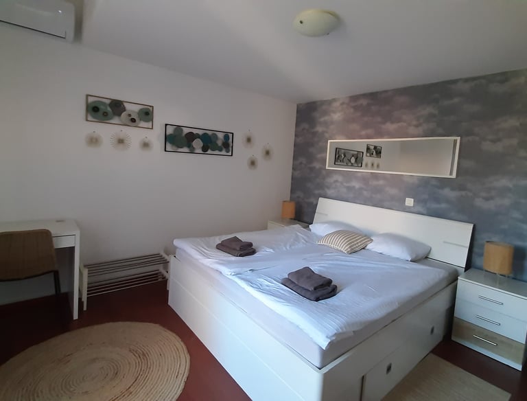 Bright bedroom with king-size bed in family apartment near Pula