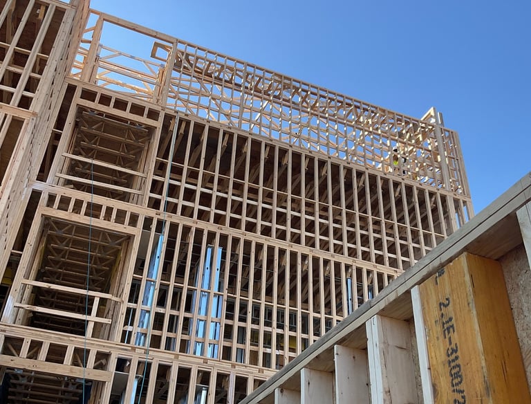 a wood paneling frame building being built with all Safety Measures by OSHA