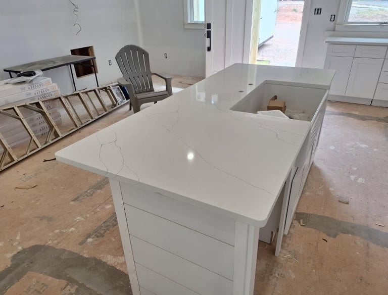 close up of quartz on a island with farm sink