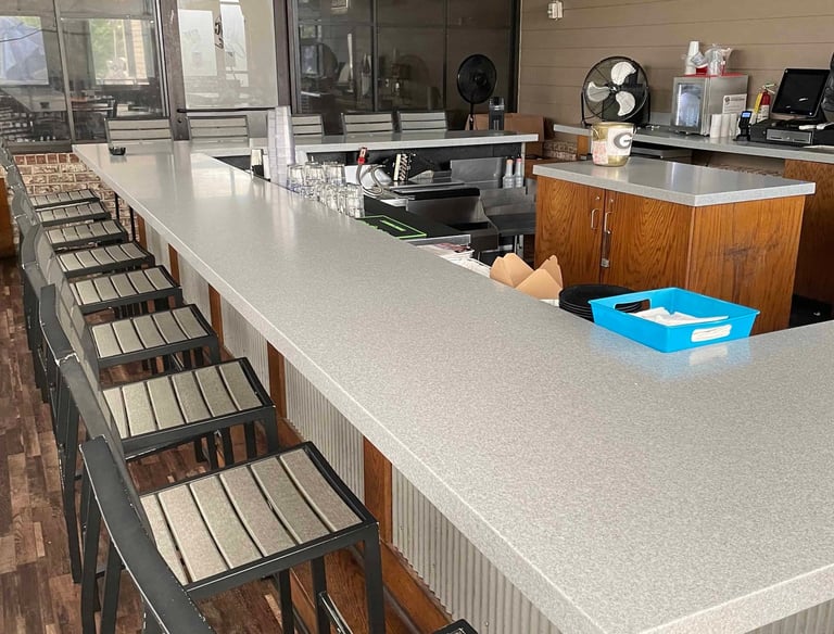 close look at a C shape granite countertop for bar area