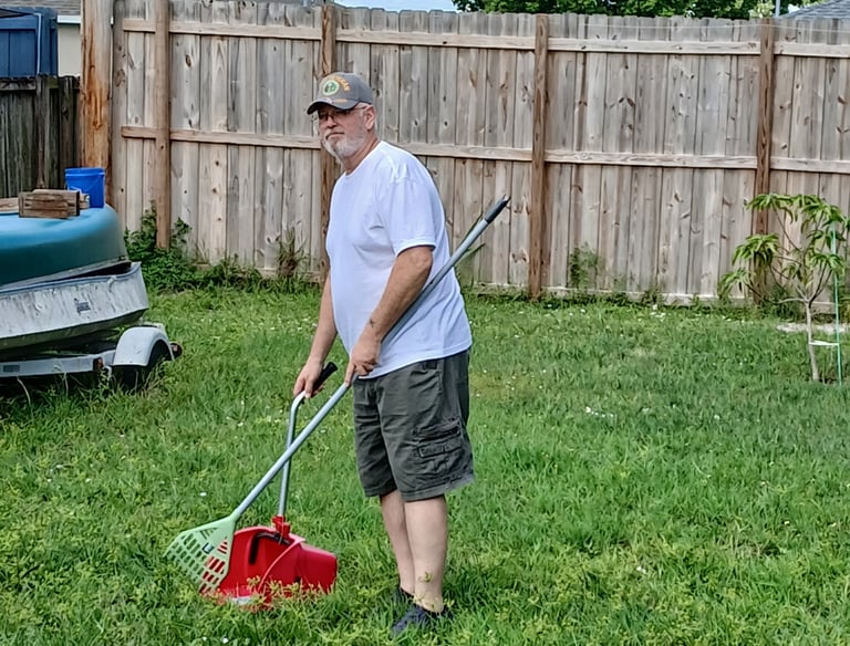 Robert using a sanitized scooper to remove waste from a customers back yard