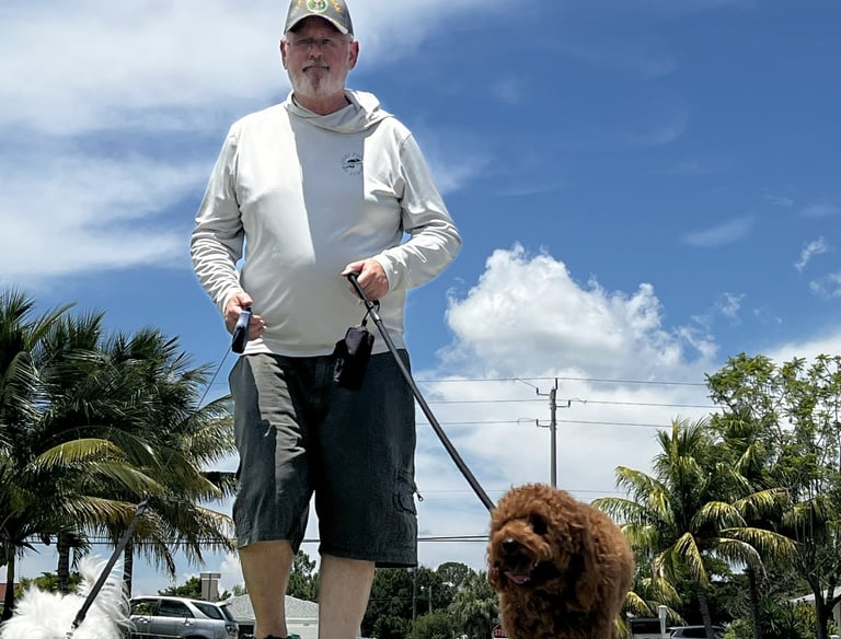 robert walking customers dogs in port saint lucie wearing a back's yard poop scooping shirt