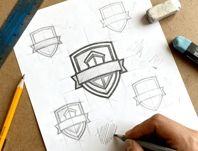 a person is drawing a logo on a piece of paper