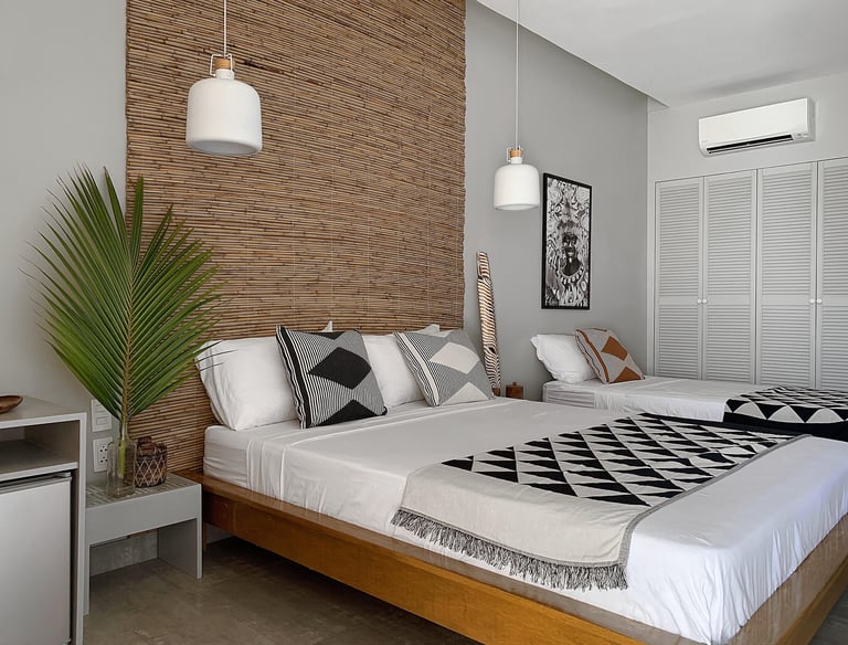 Deluxe Family Room: a bedroom with one bed for two person and one bed for one person