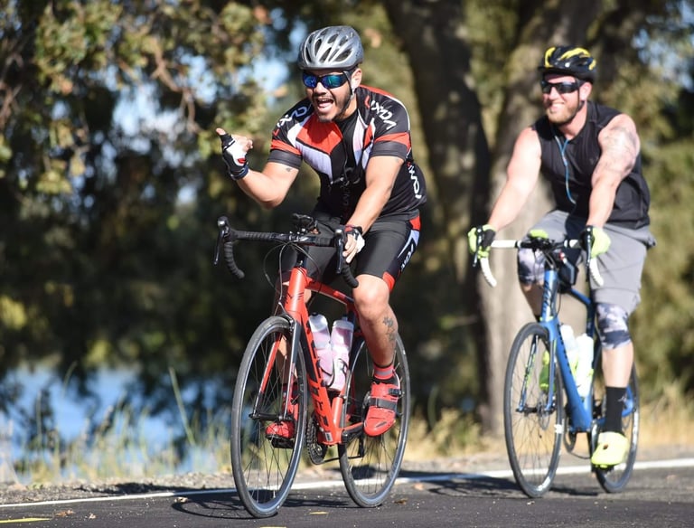 Two men riding their bikes outdoors