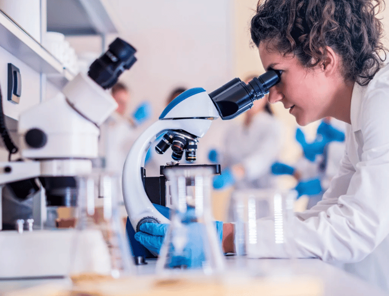 Scientist looking through a microscope