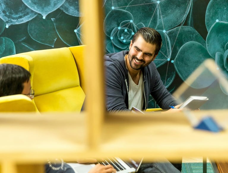 Two Men Sitting On Sofa