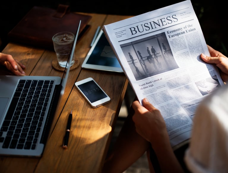 Someone reading the newspaper headlines in corporate environment