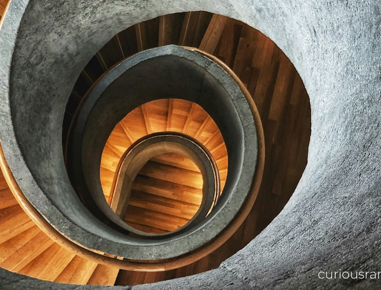 a spiral staircase way with a wooden spiral staircase
