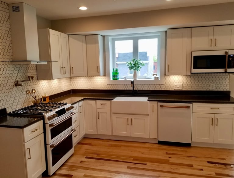 Dark granite white cabinets with cafe appliances
