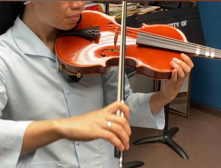 Violin lessons student practicing with violin and bow