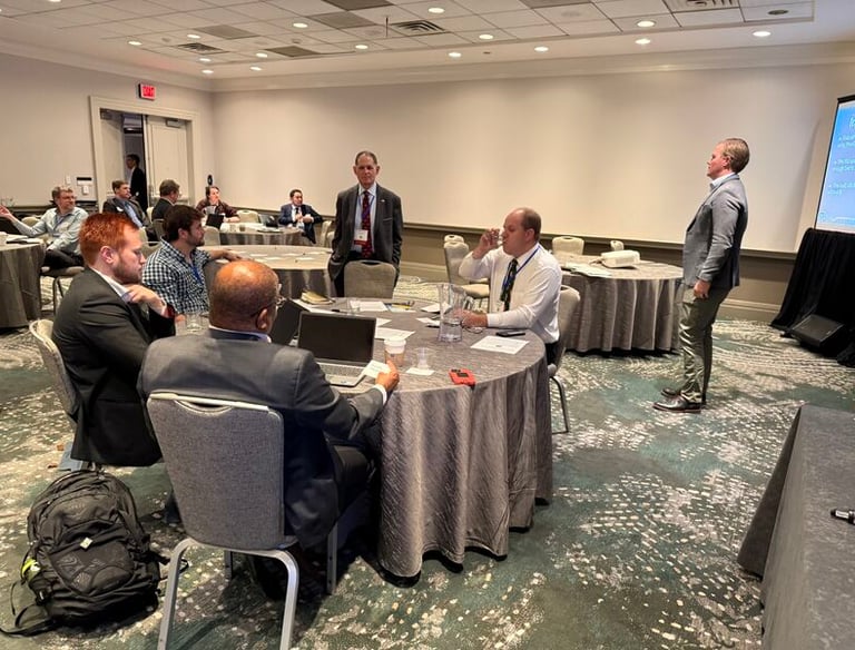 Nick Reese facilitating crisis simulation with several people in suits participating