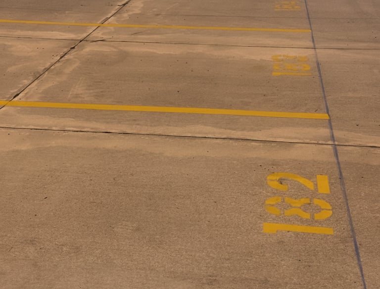 yellow lines with stenciled numbers in parking lot