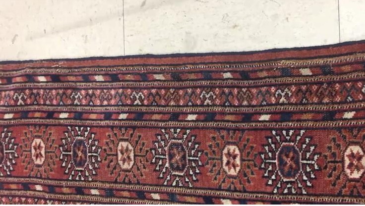 Professional rug restoration repairing worn edges, tears, and holes with precision care.