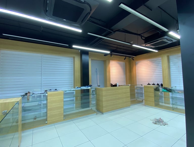 a room with a desk and a glass wall