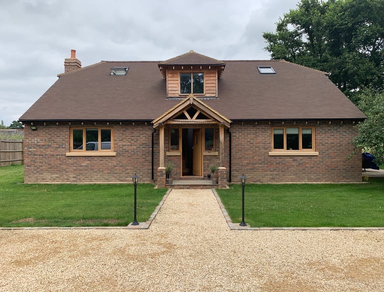 A new build chalet bungalow with oak framed windows and porch