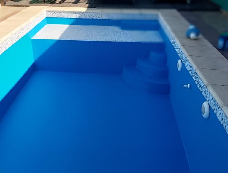 a pool with a blue pool and a pink ball