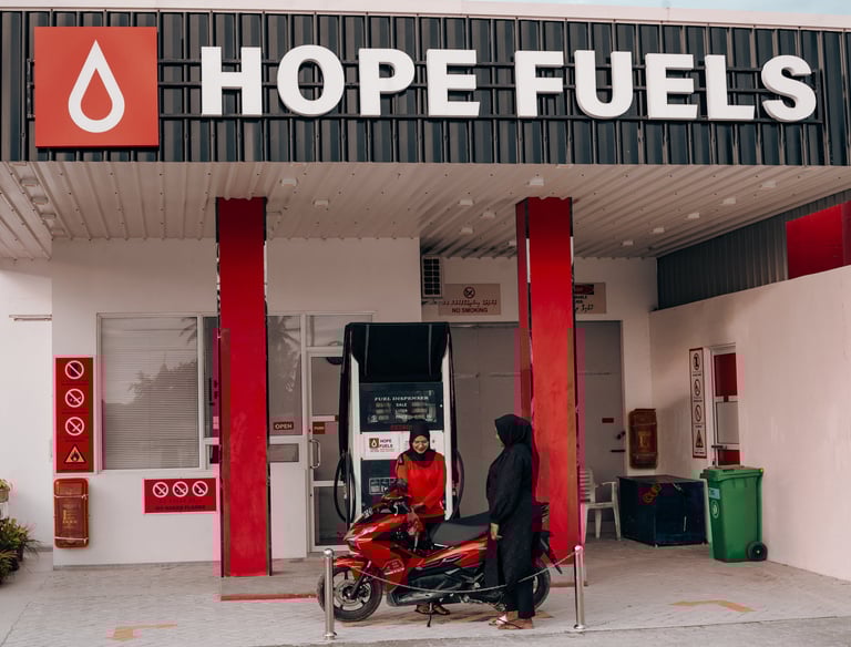 a sales associate refilling gas a motorcycle from a dispenser
