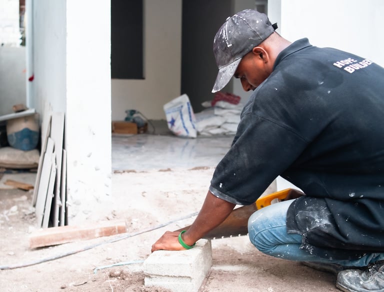 a man in a black shirt engaged in construction work