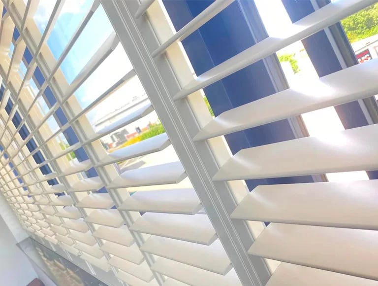 Hard wood shutters fitted in a sunny window