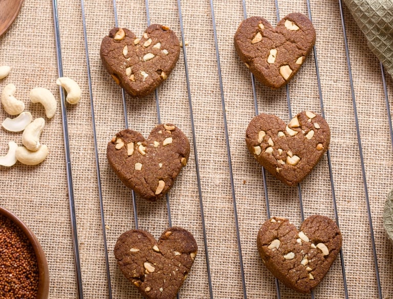 Heart-shaped ragi cookies with cashew nuts on top