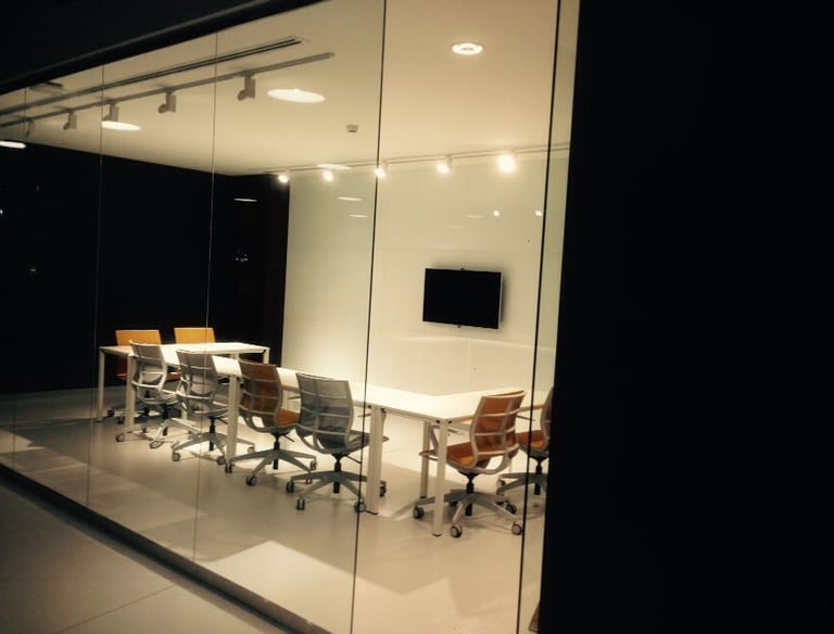 Modern open-plan office featuring recessed linear LED lighting with low-glare optics for employee pr